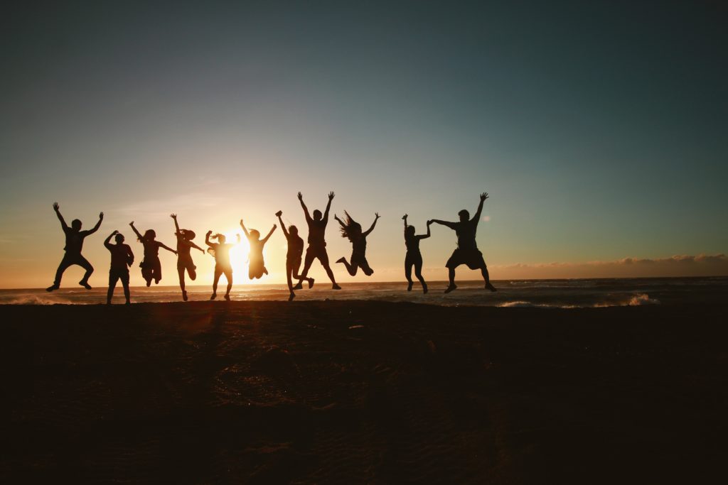 People on beach jumping